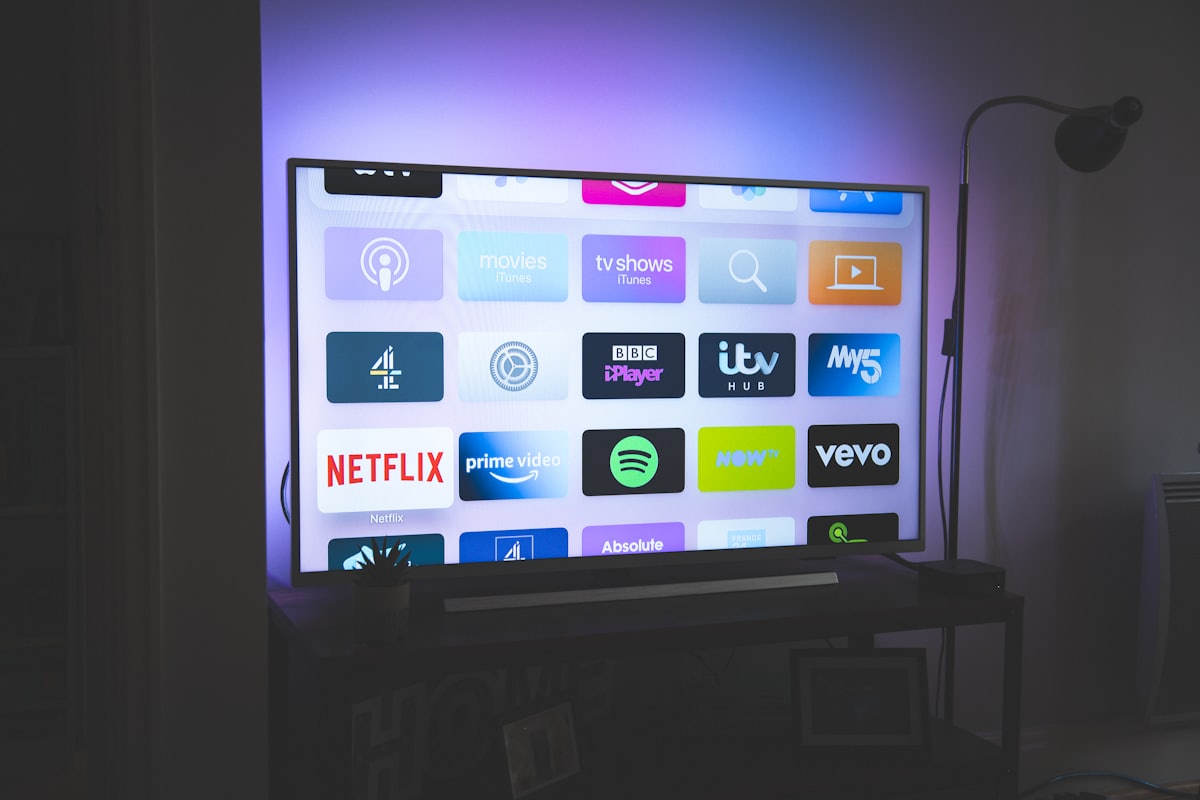 Streaming stick plugged in near a television, a typical example of a box used for IPTV.